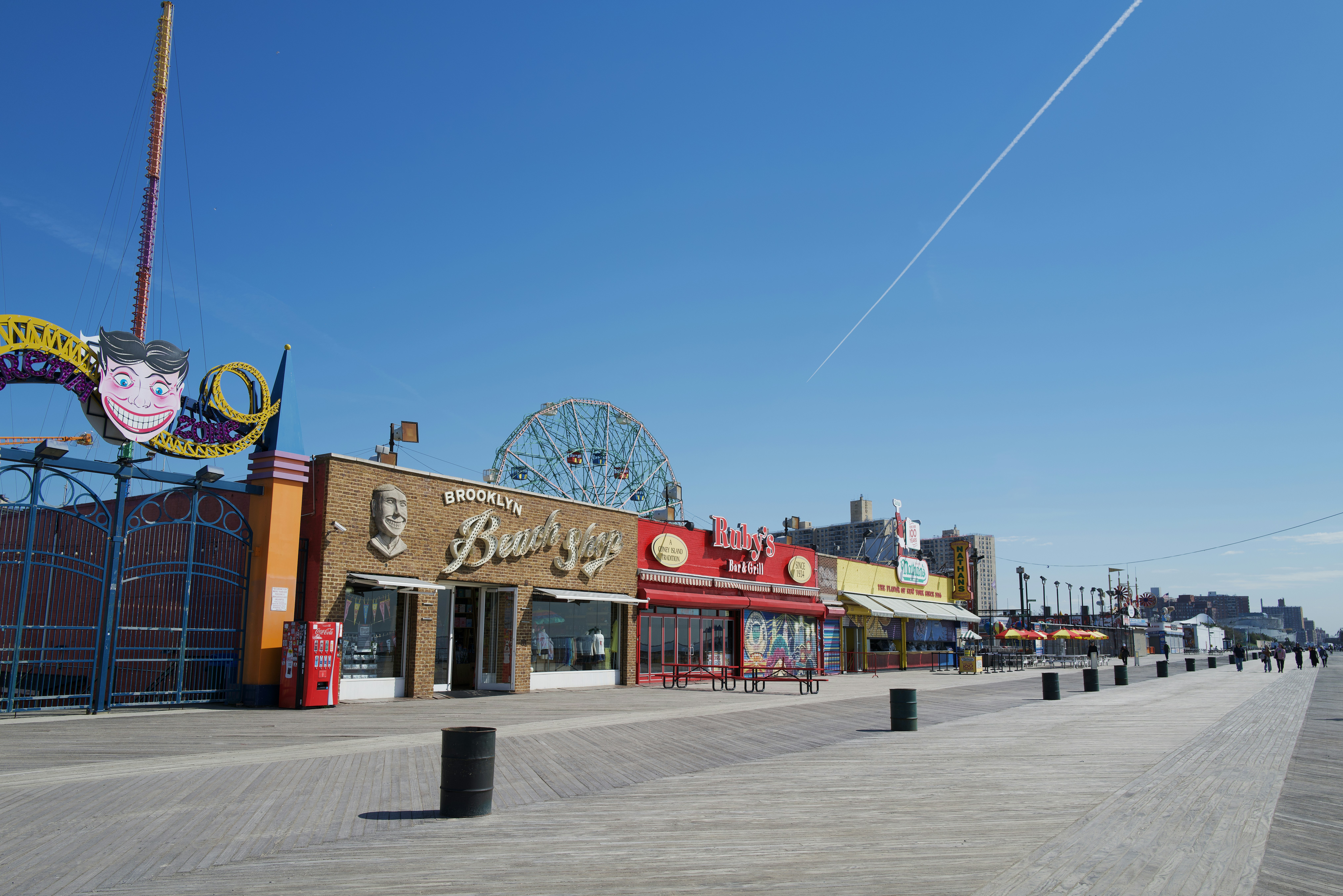 A row of buildings with a ferris wheel in the background