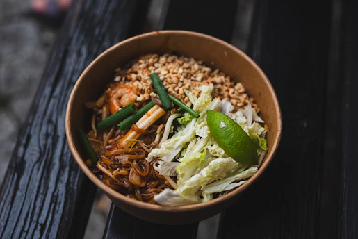 A bowl of food sitting on top of a wooden table