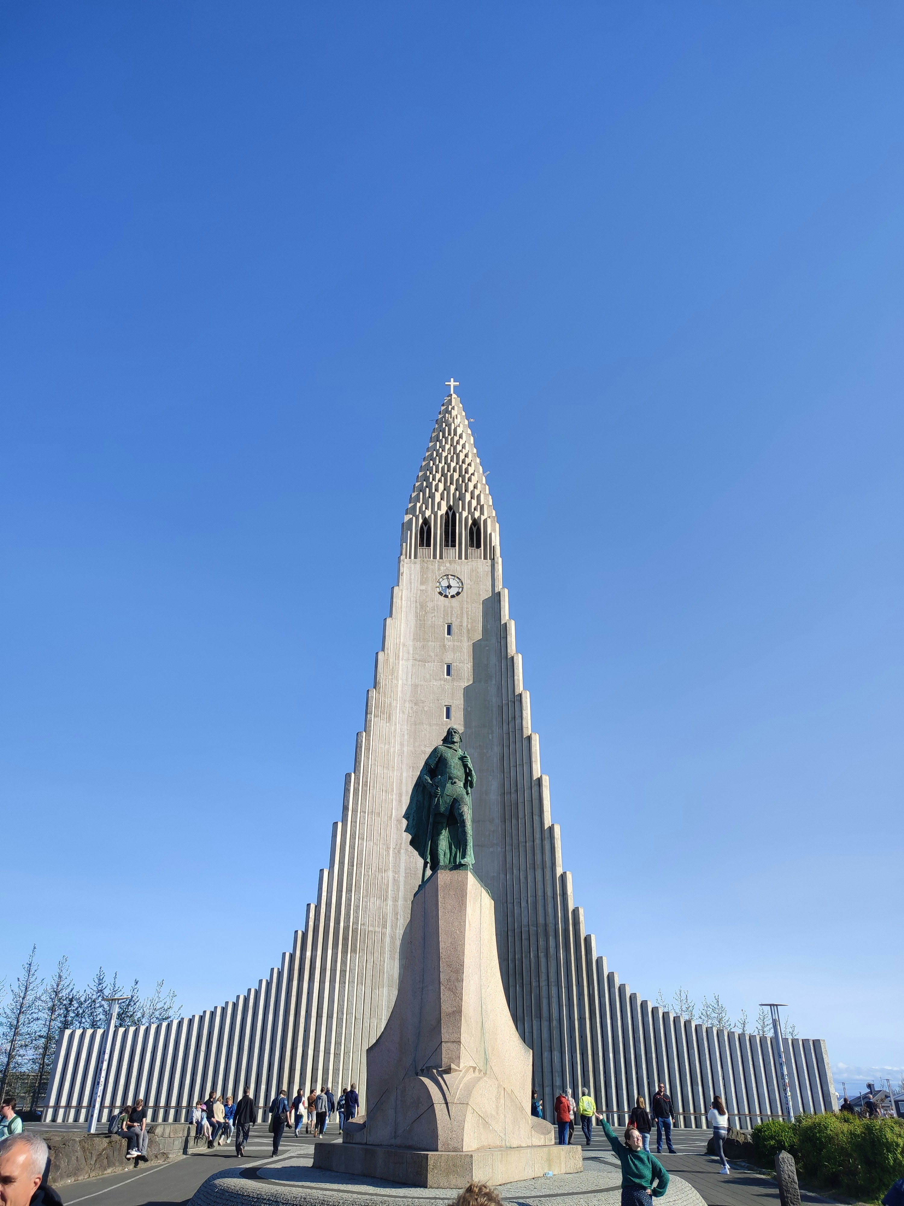 A very tall building with a statue in front of it