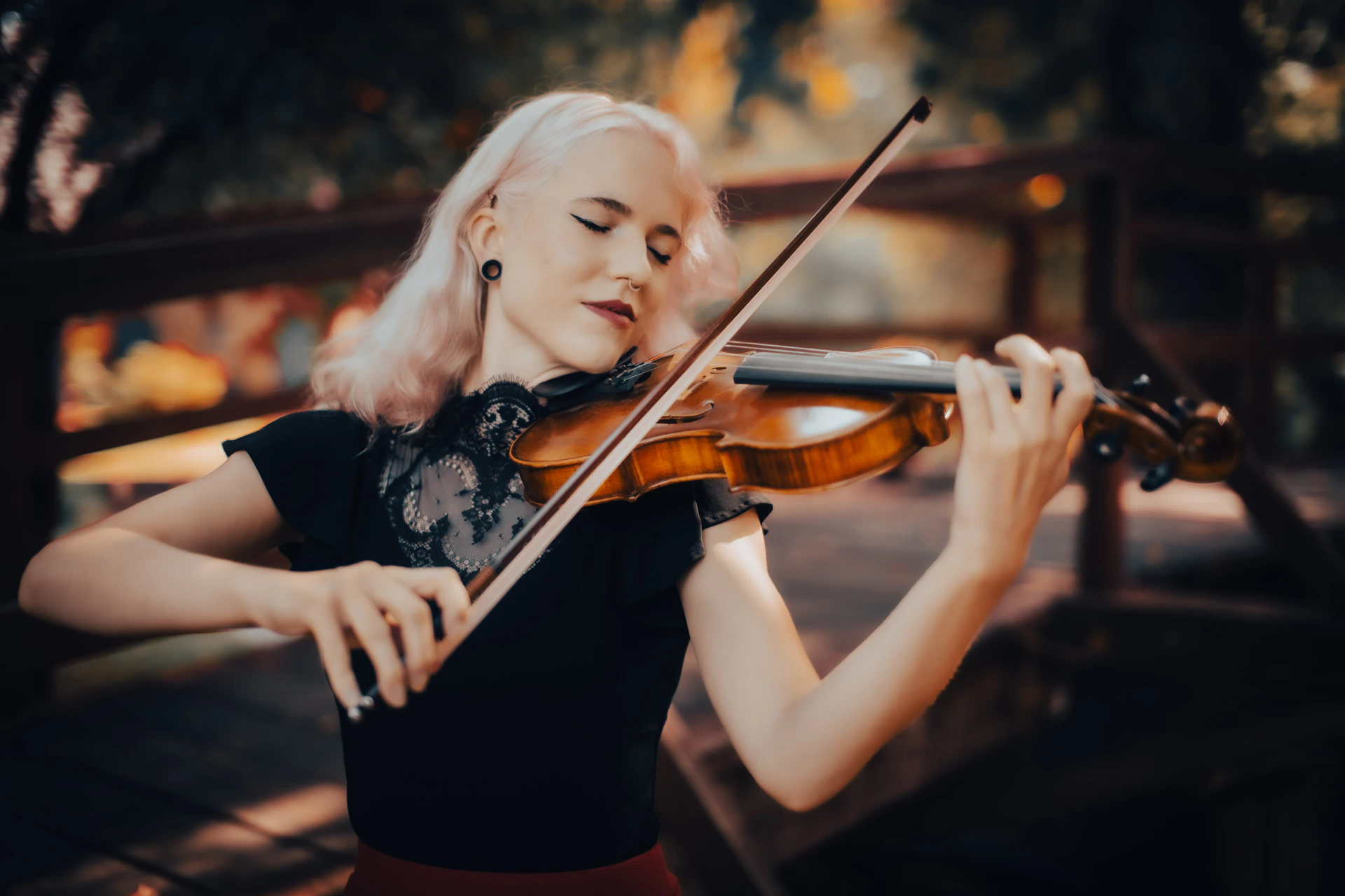 A woman playing a violin in a park