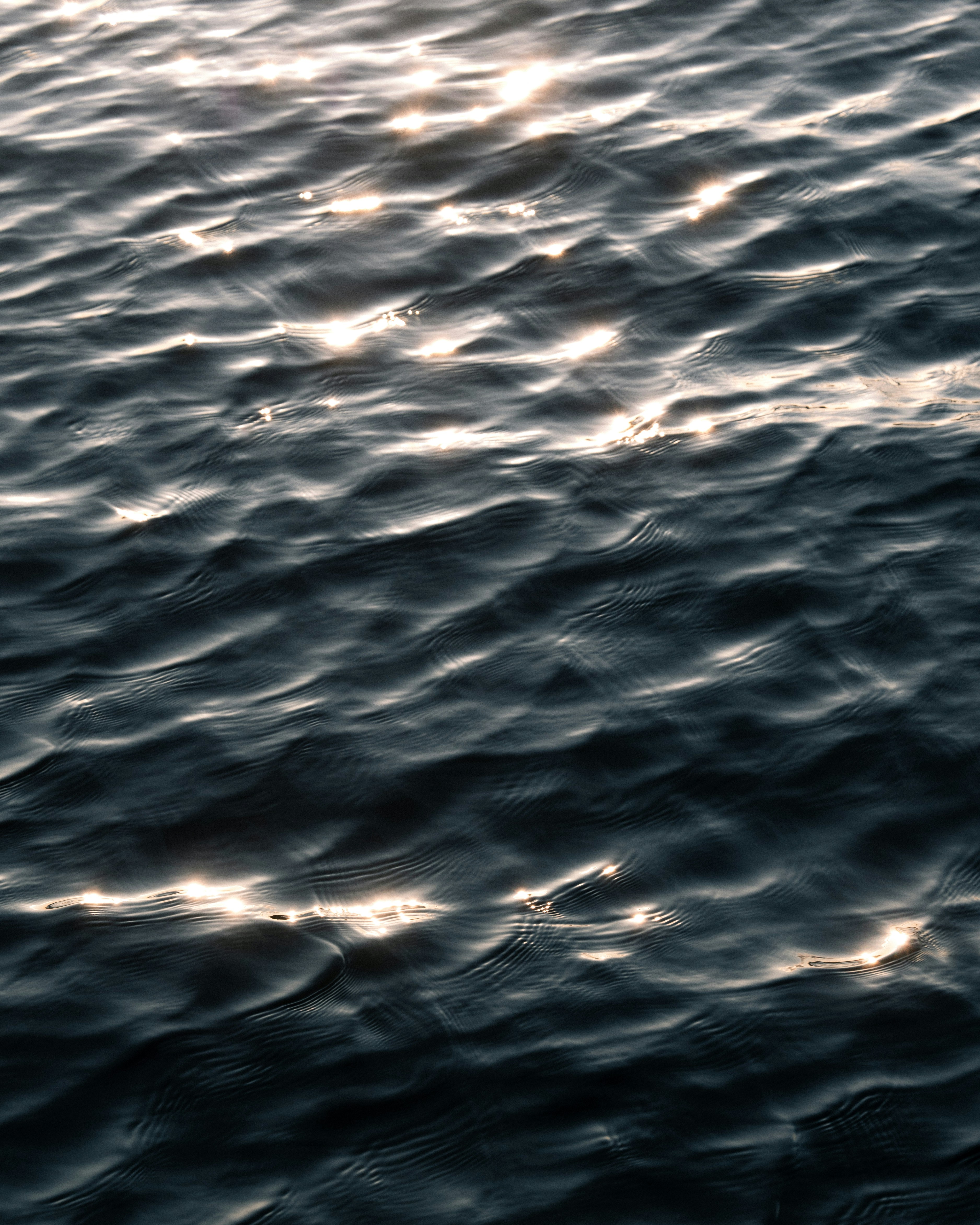 Dark water body with light refraction
