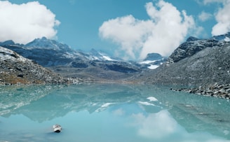 A body of water with mountains in the background
