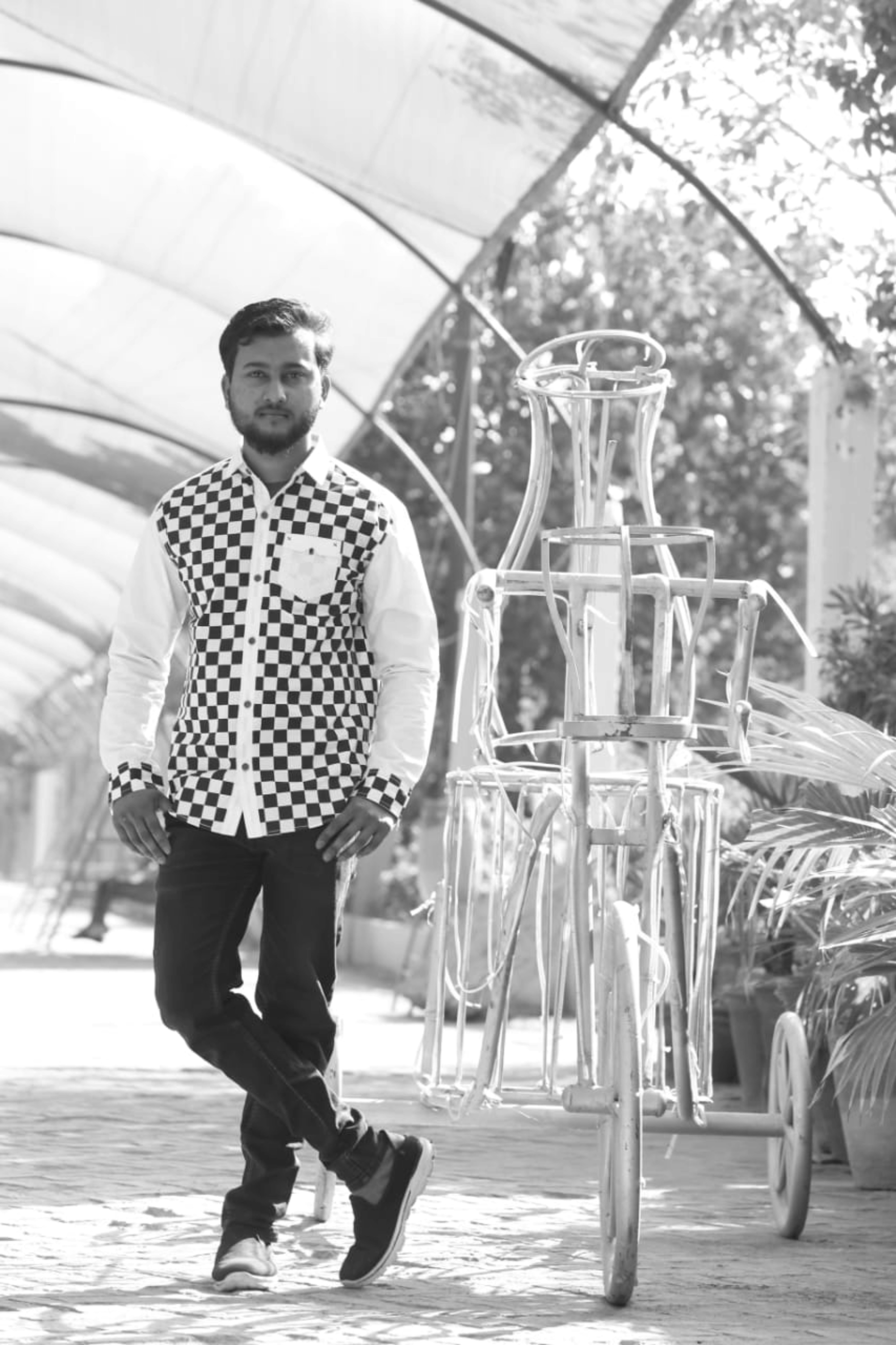 A man standing next to a bike in a building