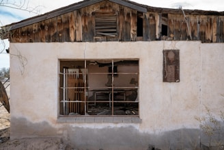 A run down house with a broken window