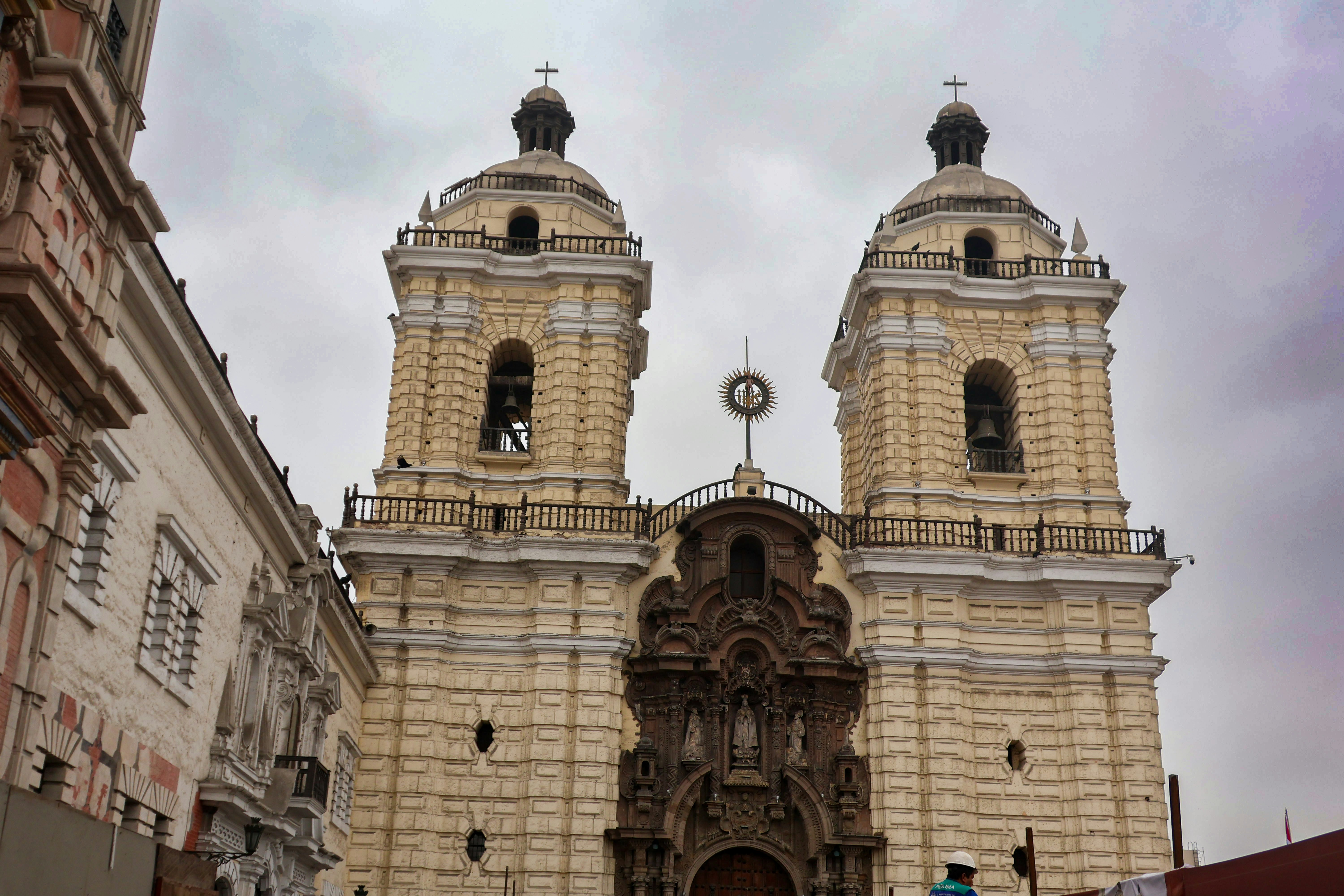 A large church with two towers on a cloudy day
