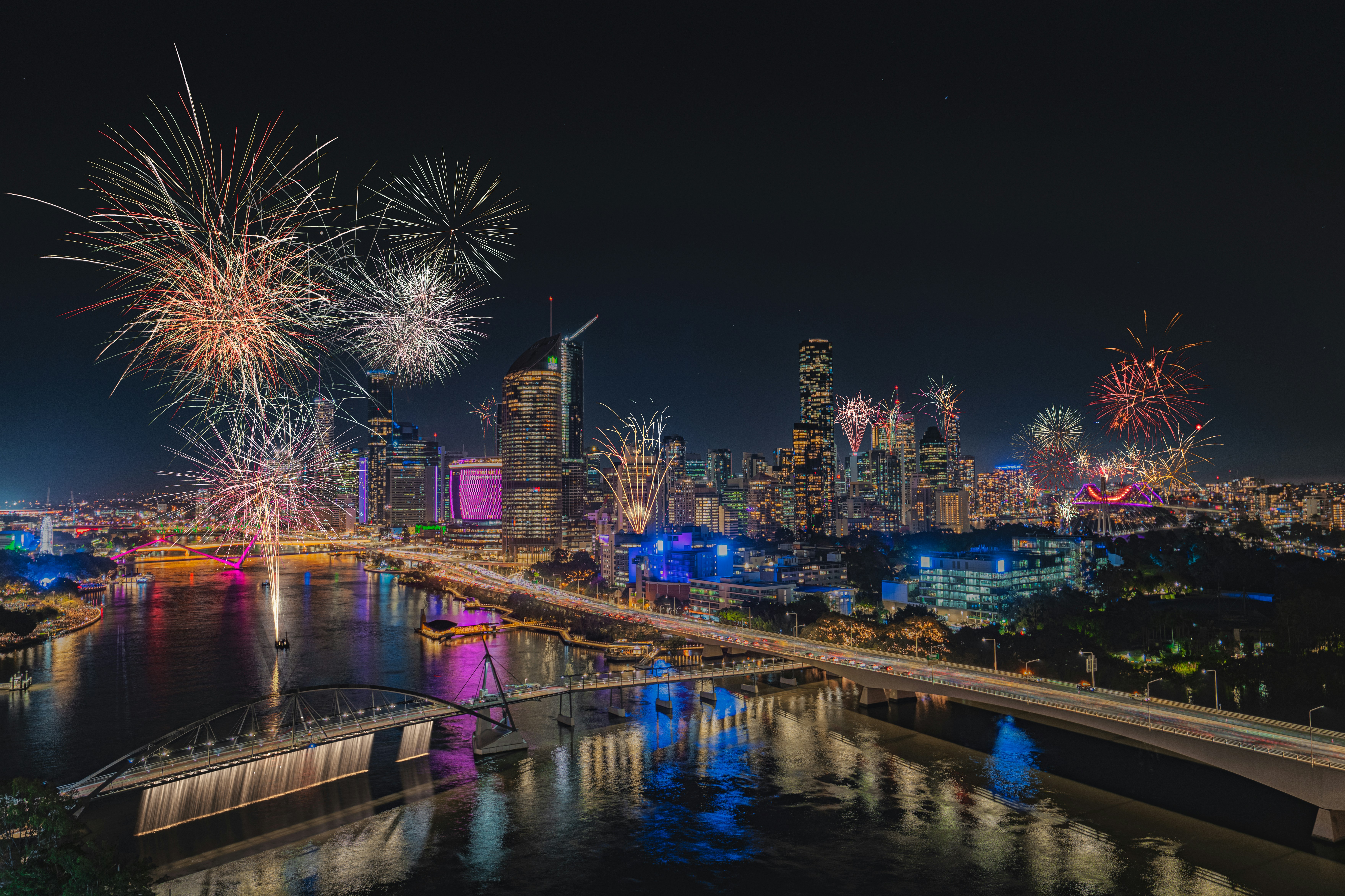 A fireworks display over a city at night