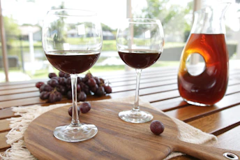 Two glasses of wine and a bottle of wine on a table