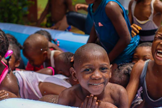 A group of children playing in an inflatable pool