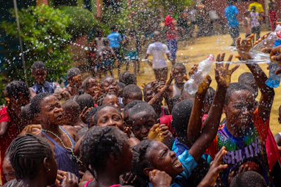 A group of people are throwing water at each other