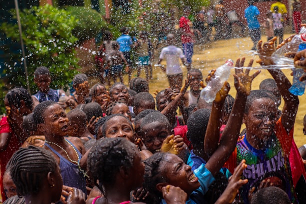 A group of people are throwing water at each other