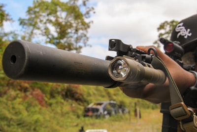 A man holding a rifle and aiming it at something