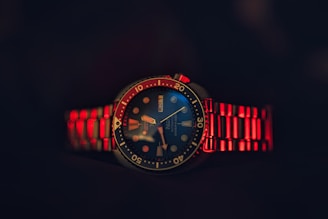 A red and blue watch with a black background