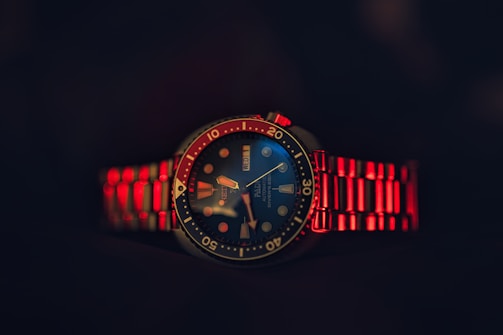 A red and blue watch with a black background