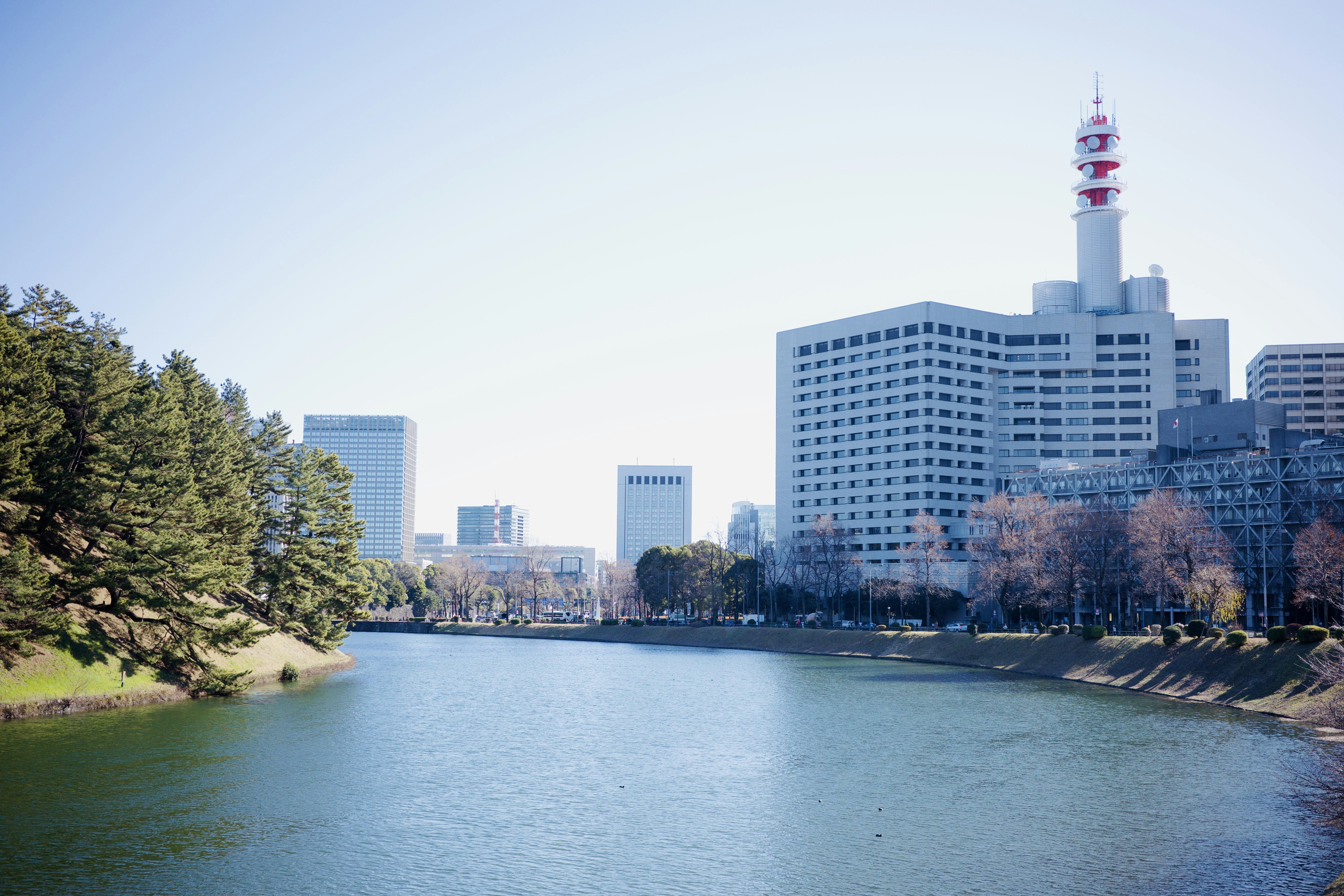 A river running through a city next to tall buildings