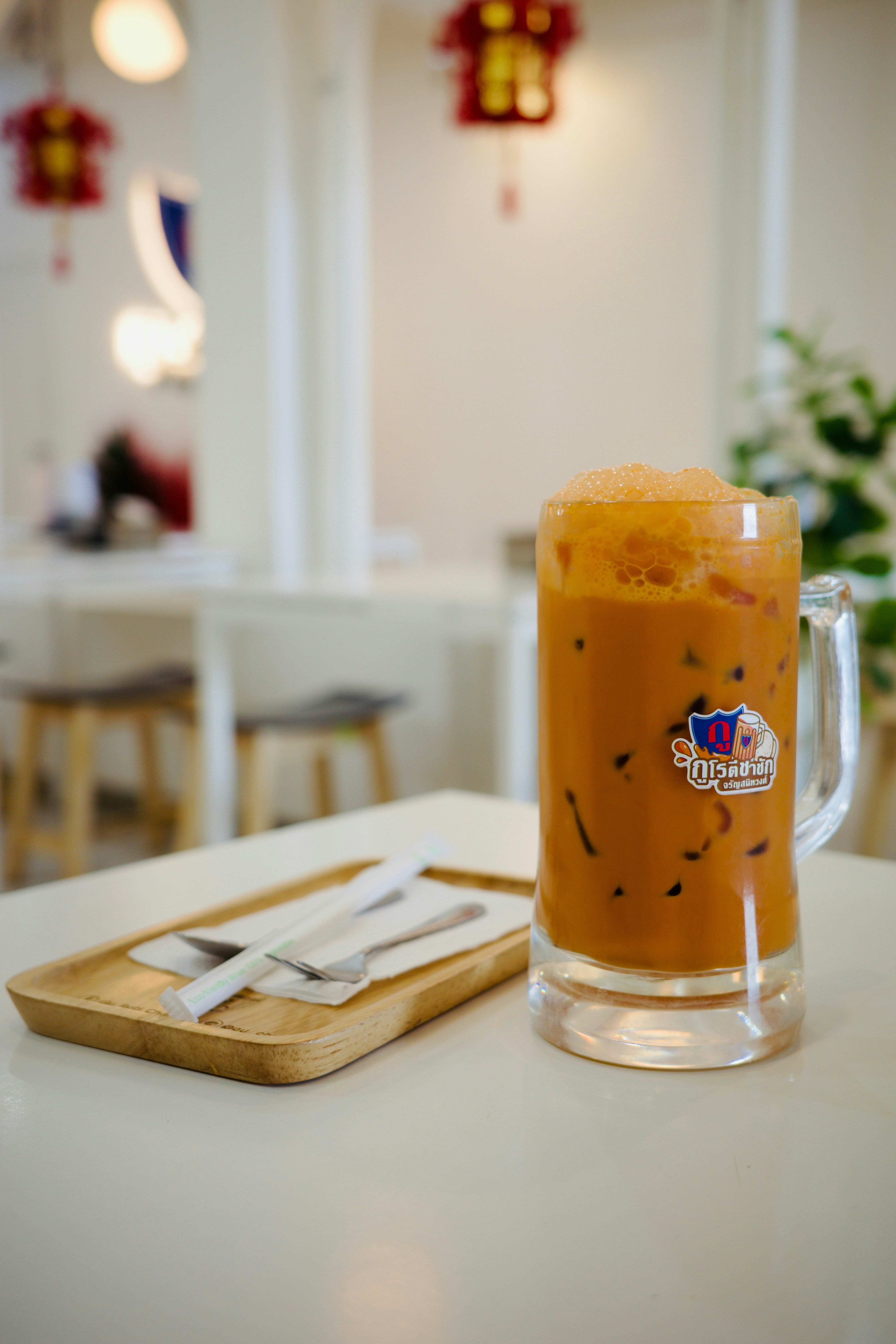 A glass of orange liquid sitting on top of a table