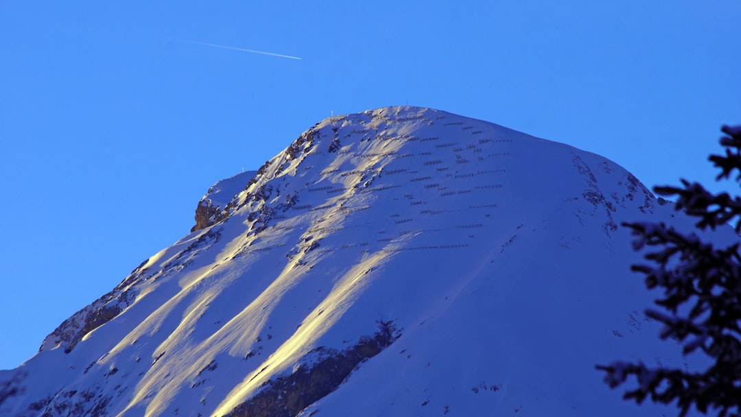 A snowboarder is doing a trick in the air,