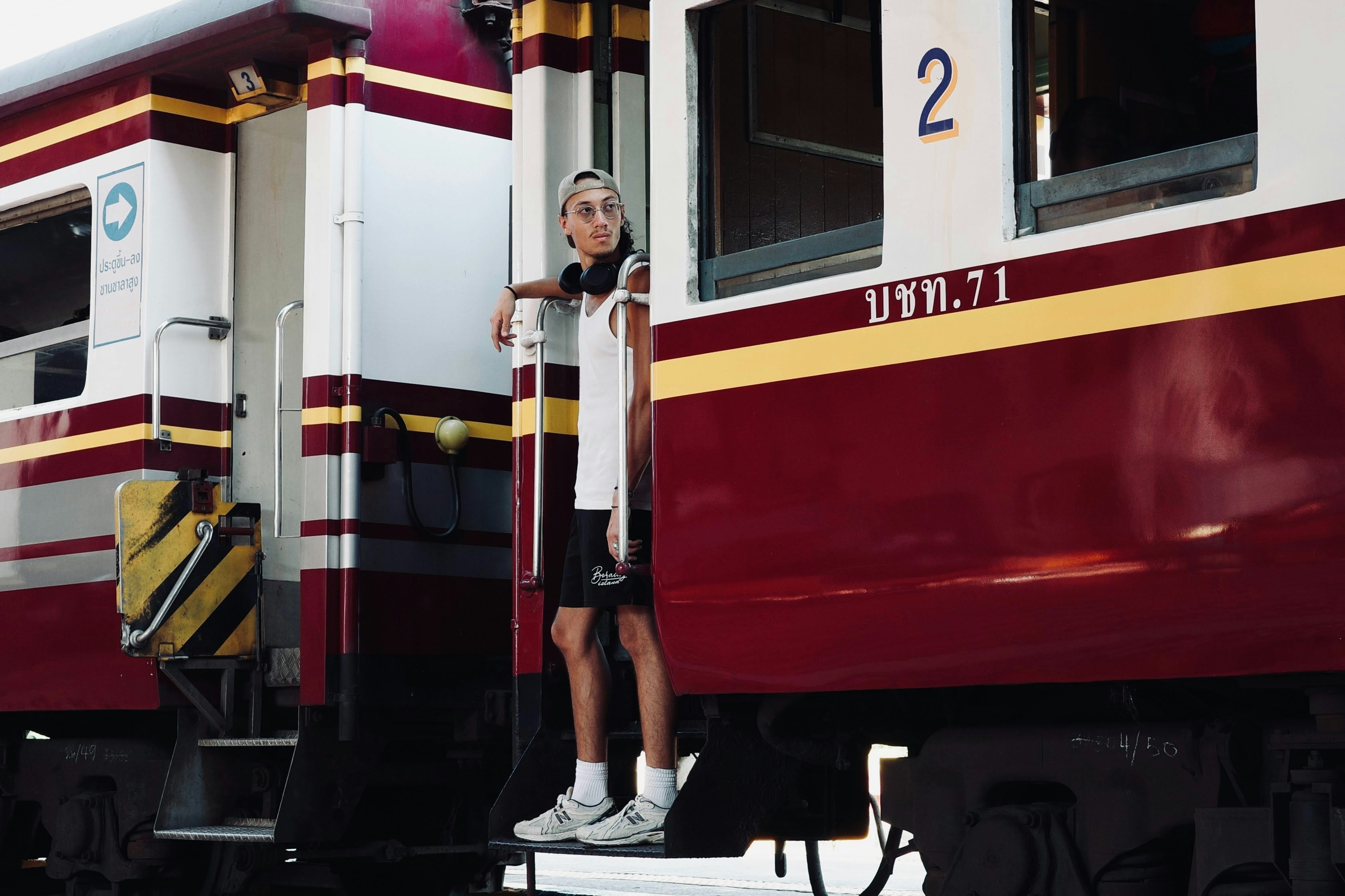 A woman standing on the side of a train