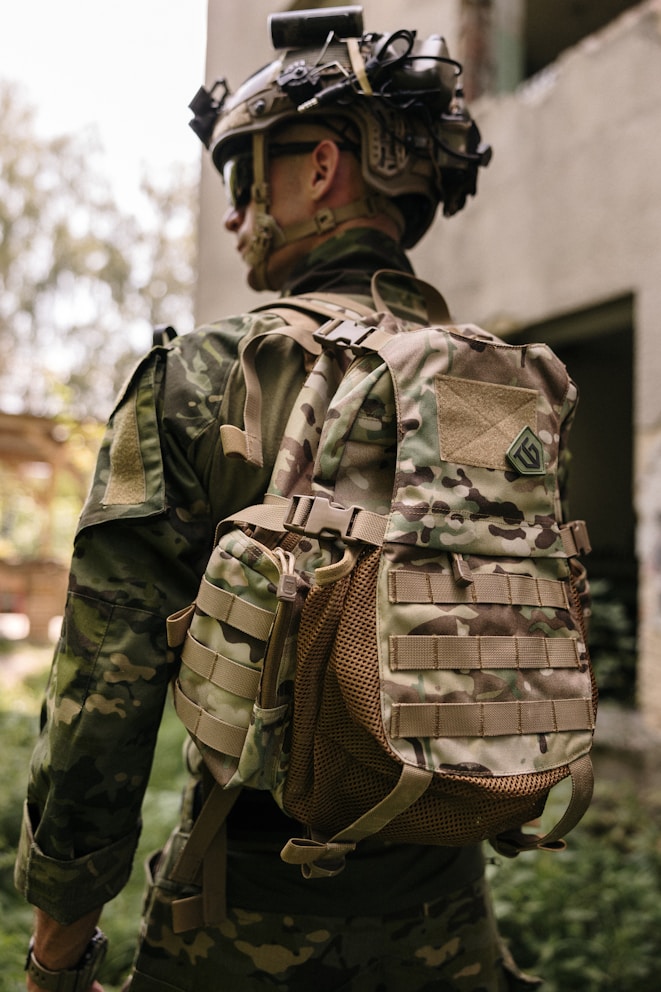 A man wearing a helmet and carrying a backpack