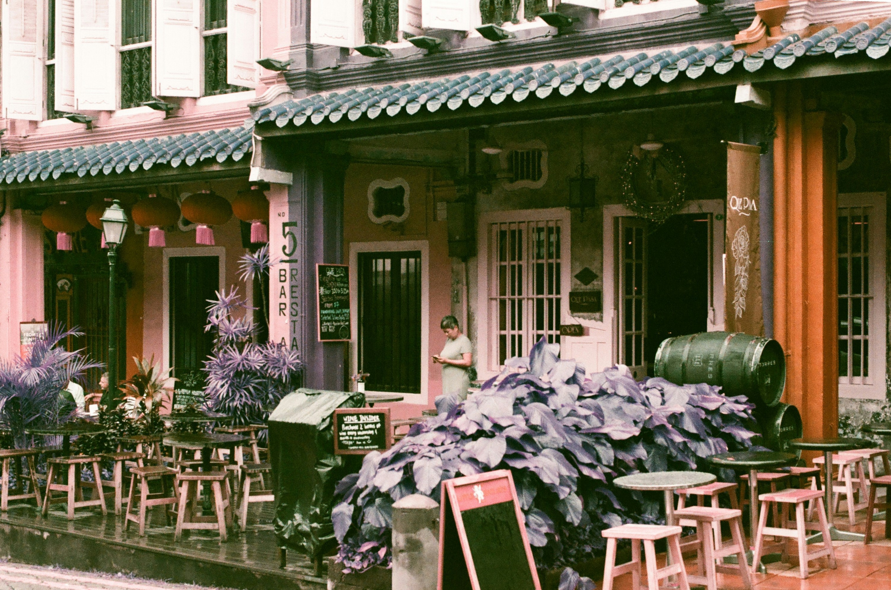 A row of tables and chairs outside of a restaurant