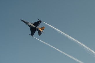 A fighter jet flying through a blue sky