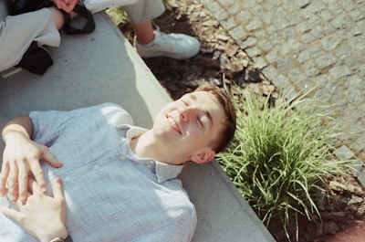 A man laying on the ground next to a woman