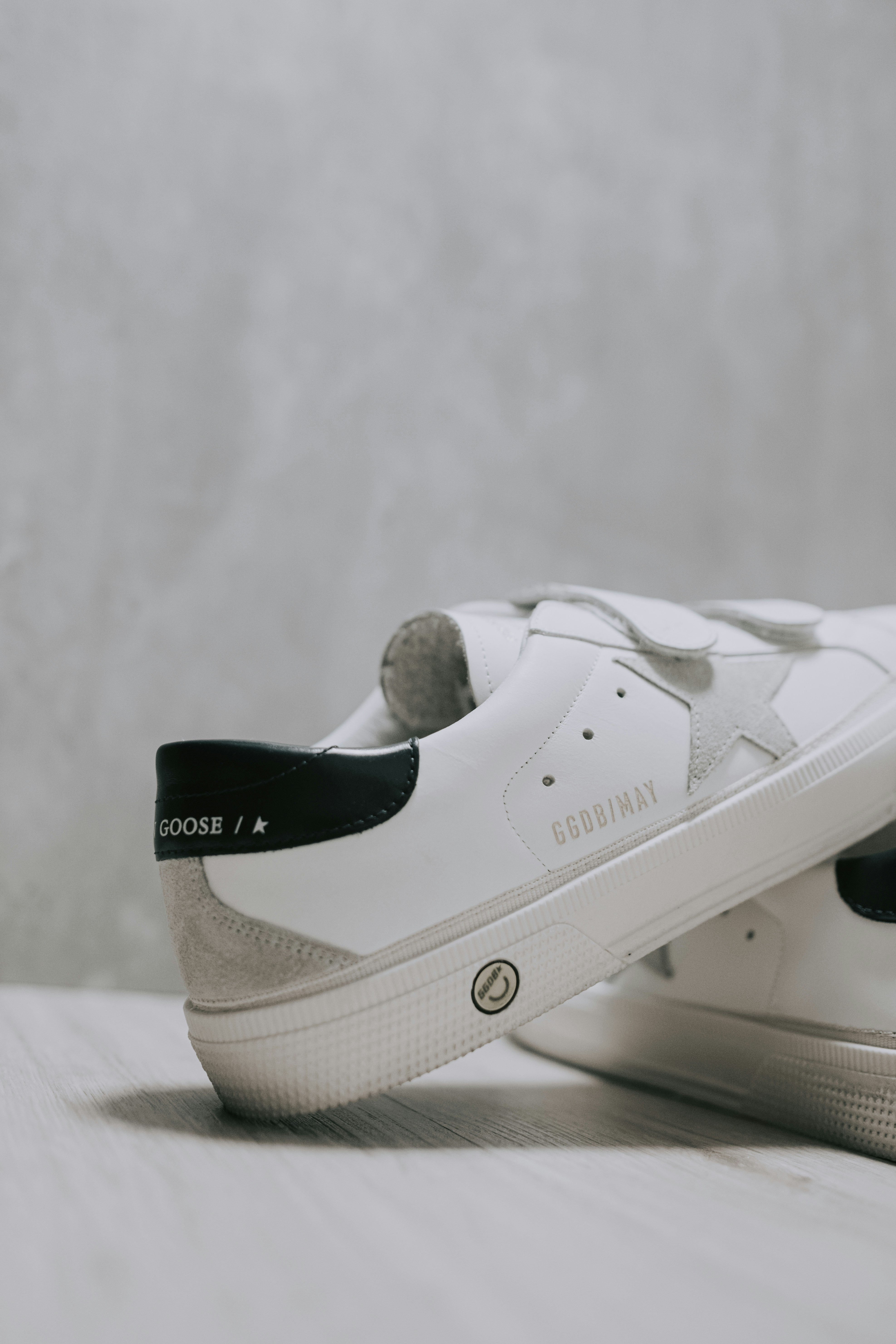 A pair of white sneakers with black laces