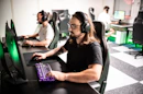 A man sitting in front of a computer with headphones on