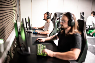 A man sitting at a desk with headphones on