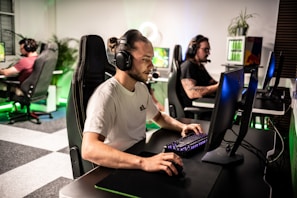 A man sitting at a computer with headphones on