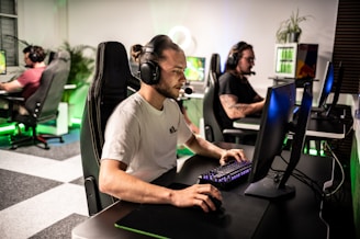 A man sitting at a computer with headphones on