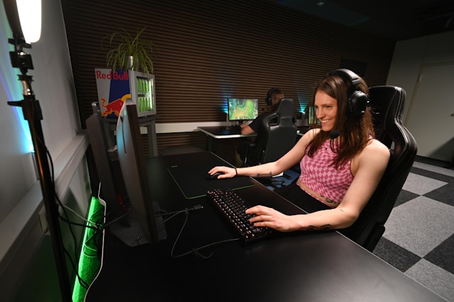 A woman sitting at a desk with headphones on
