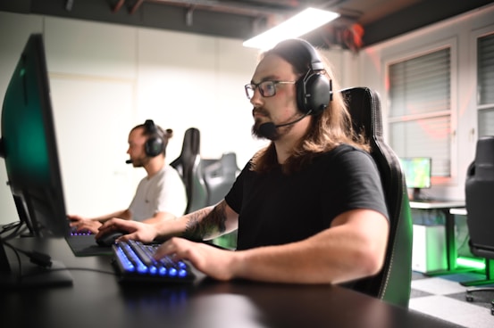 A man sitting at a computer with headphones on