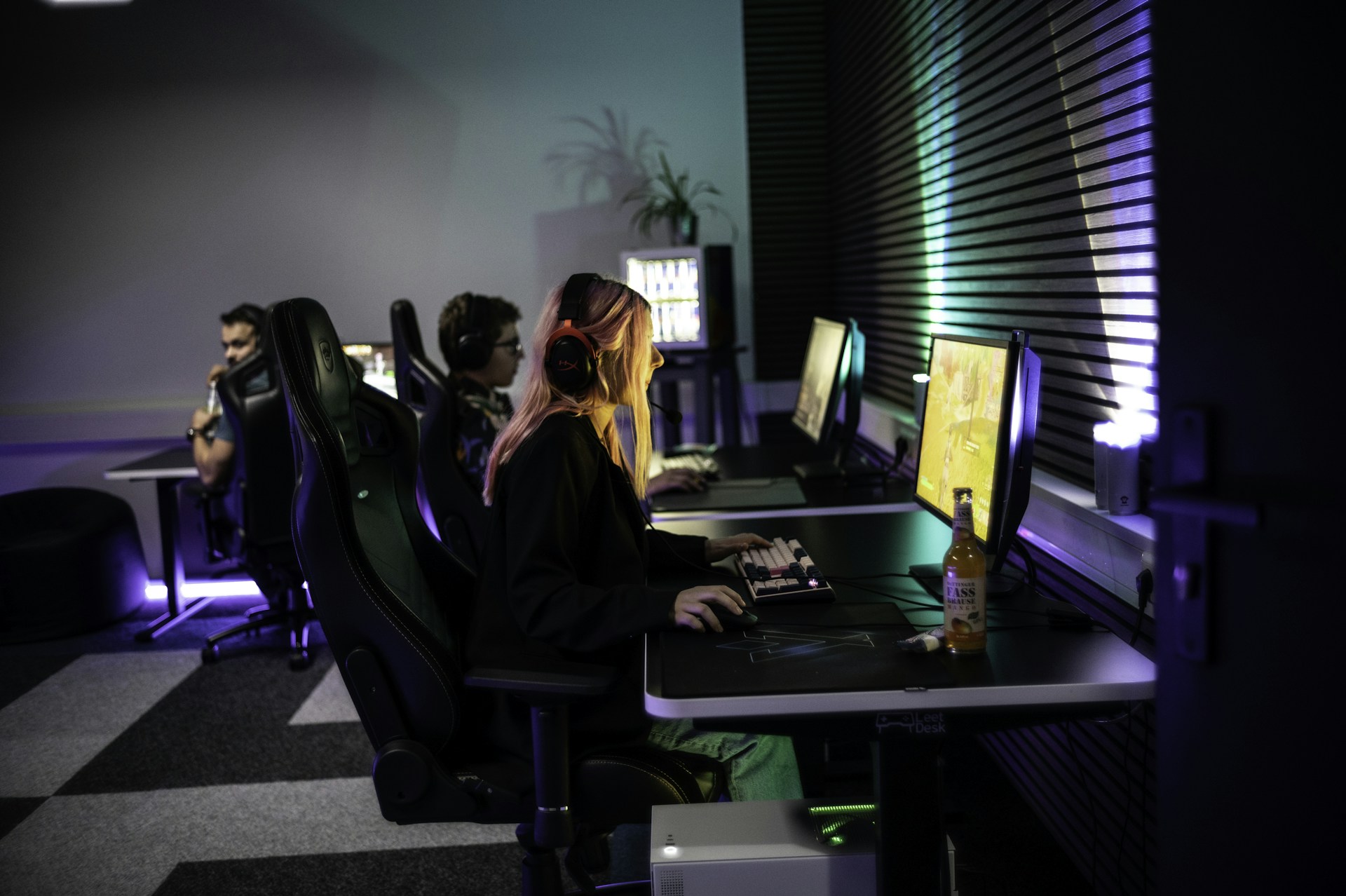 A couple of people sitting at a computer desk