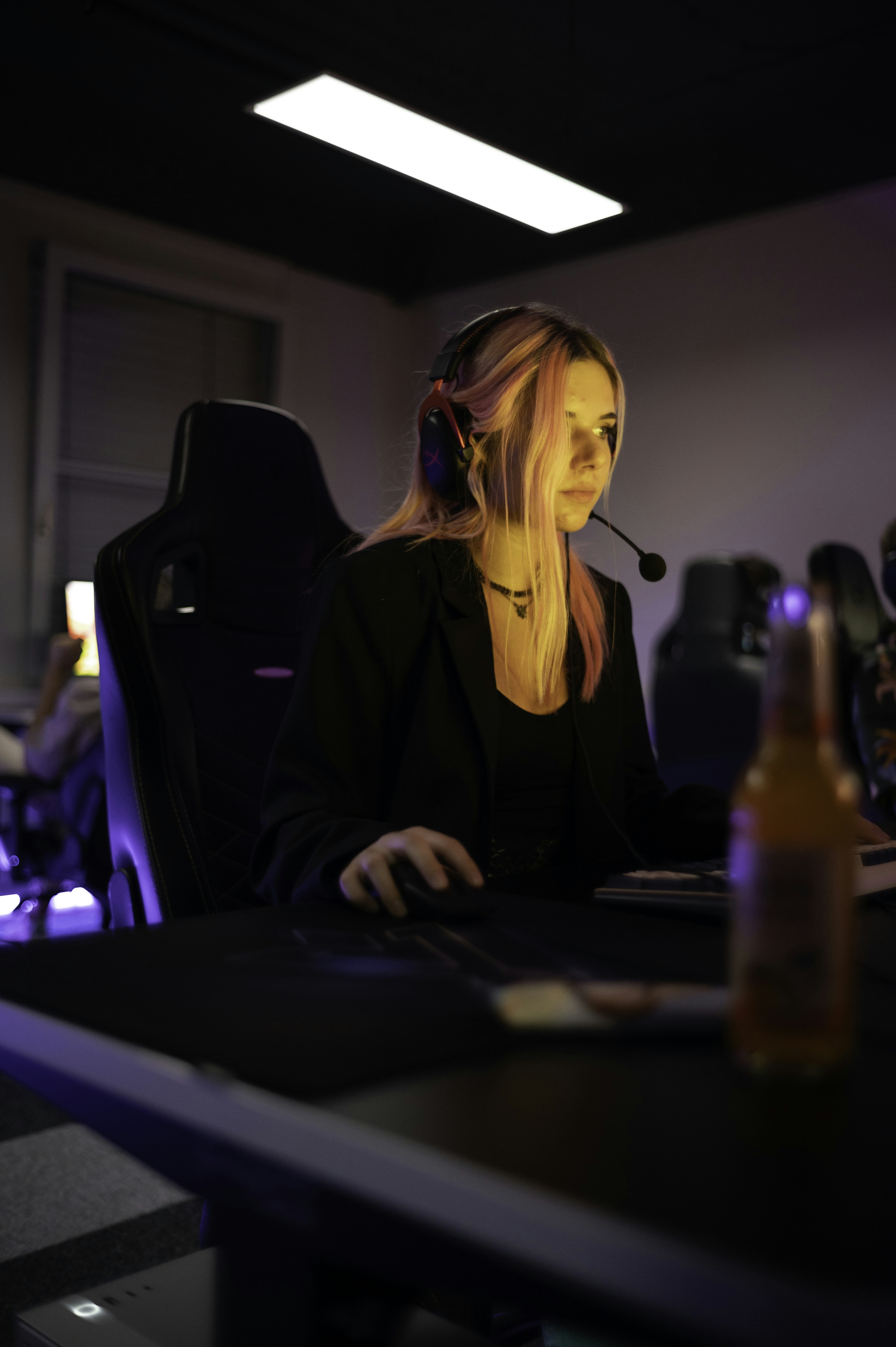 A woman sitting at a desk wearing a headset