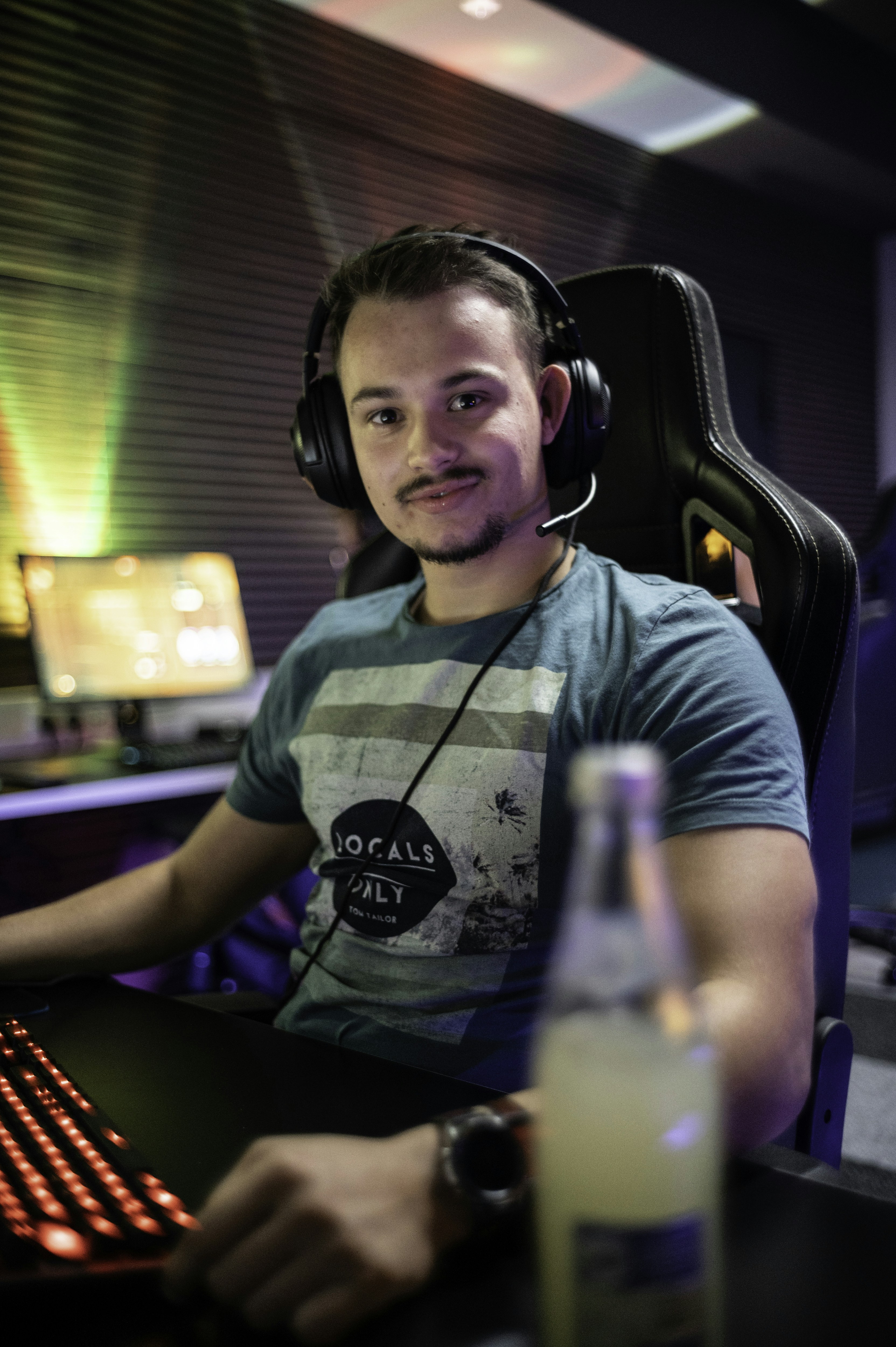 A man sitting in front of a computer with headphones on