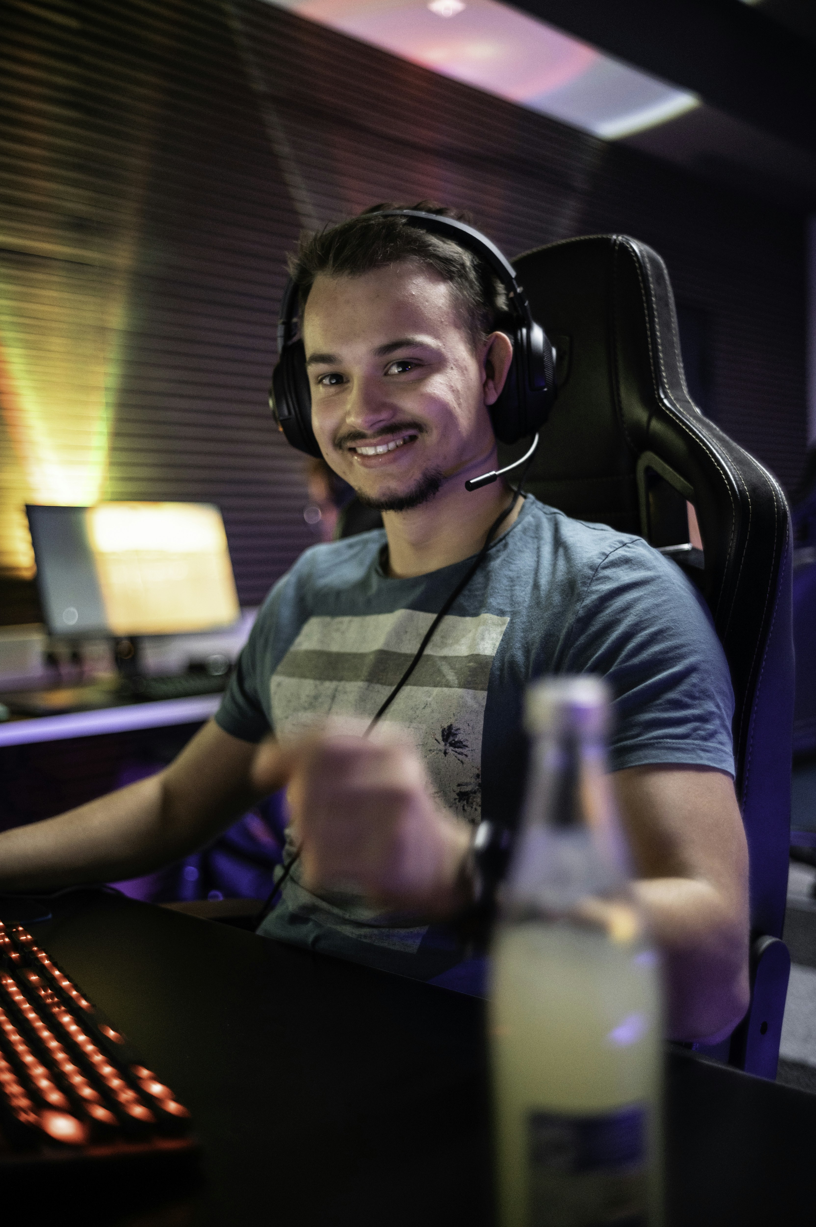 A man sitting in front of a computer with headphones on