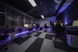 A group of people sitting in a room with a checkered floor
