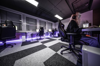 A man sitting in a chair in a room with a checkered floor
