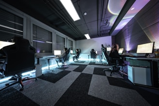A group of people sitting in a room with computers