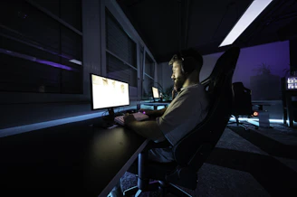 A man sitting at a desk in front of a computer