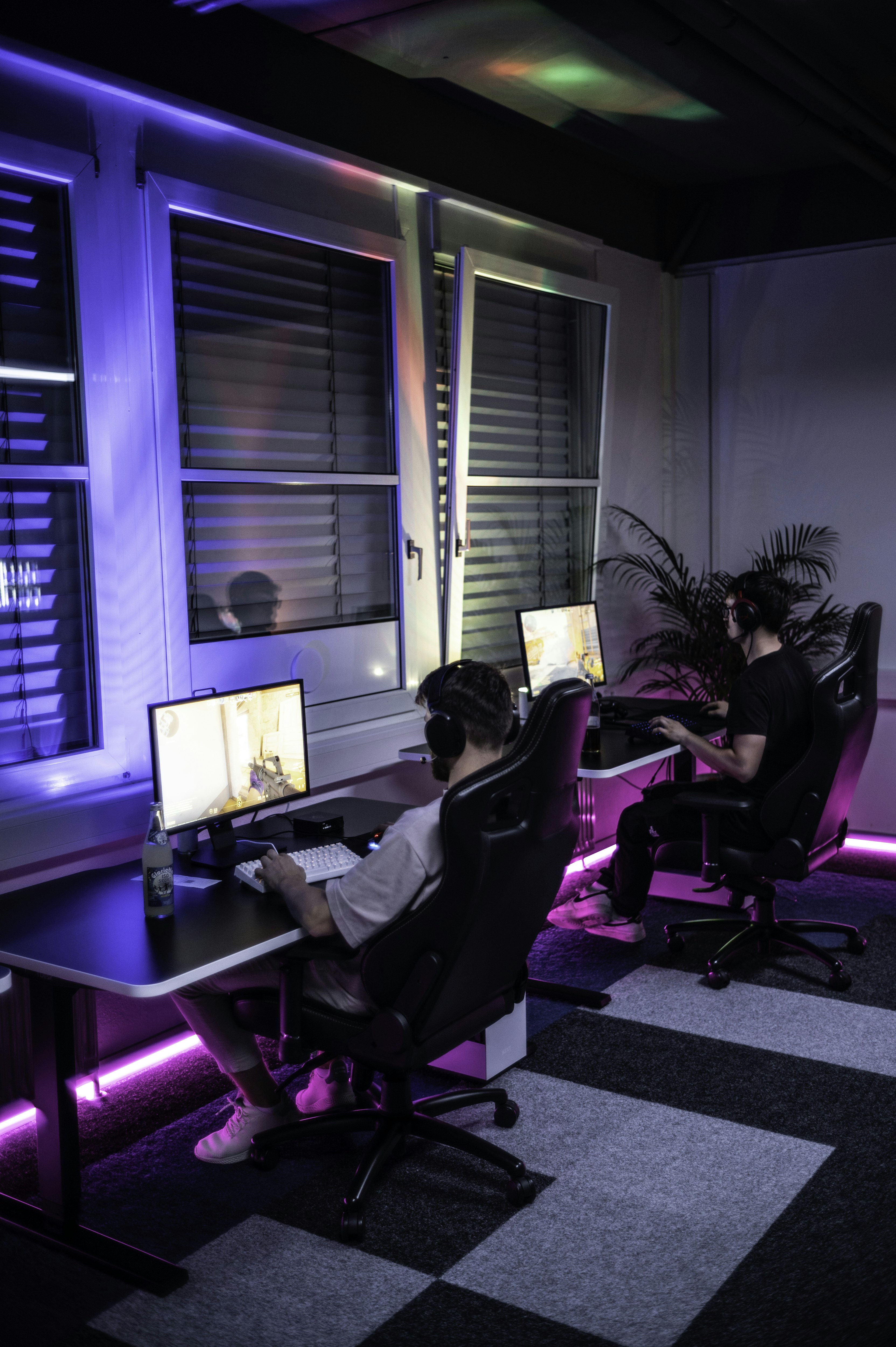 A couple of people sitting at a computer desk