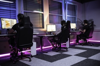 A group of people sitting at computers in a room