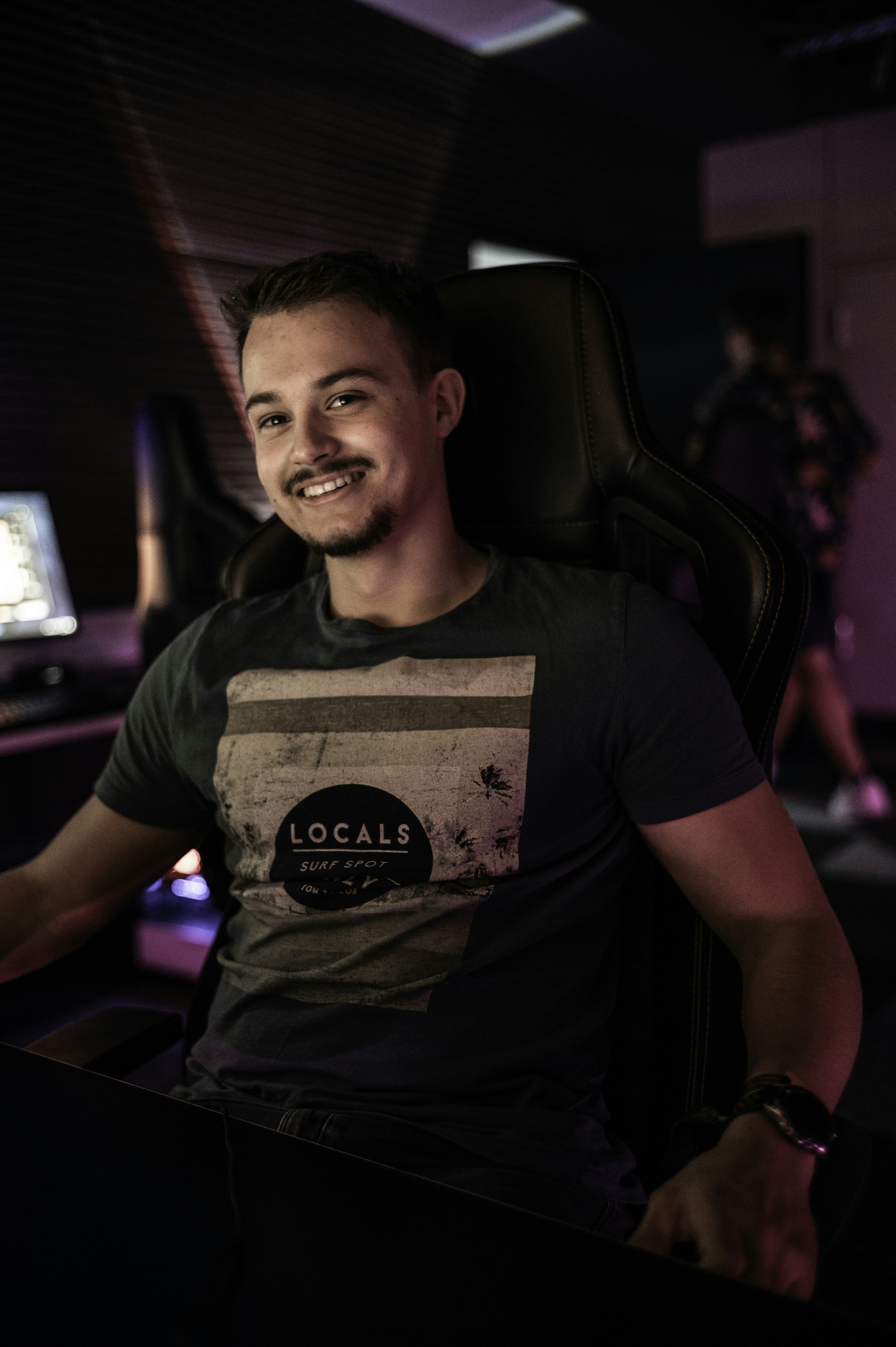 A man sitting in front of a computer desk