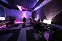 A group of people sitting in a room with computers