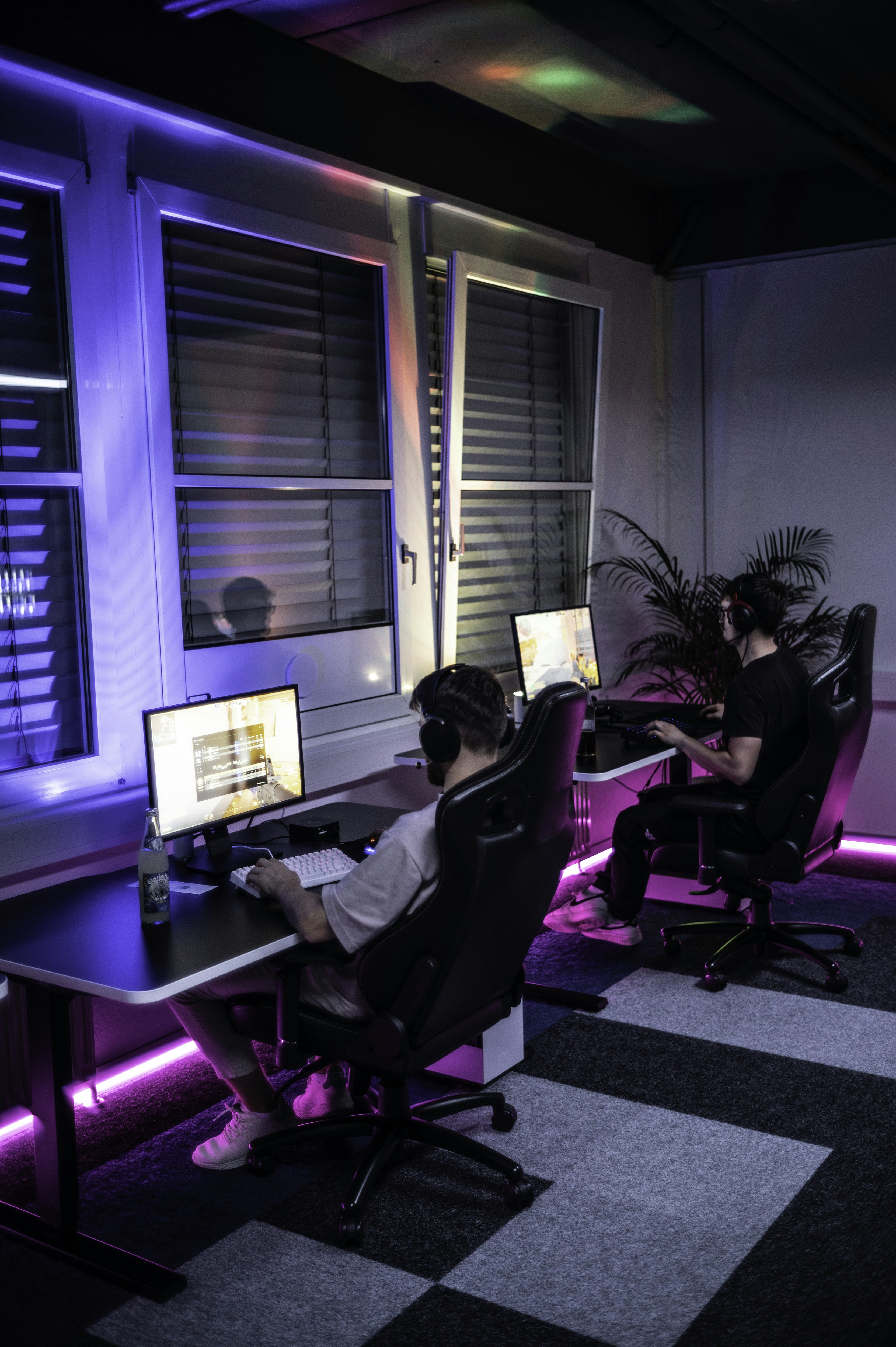 A couple of people sitting at a computer desk
