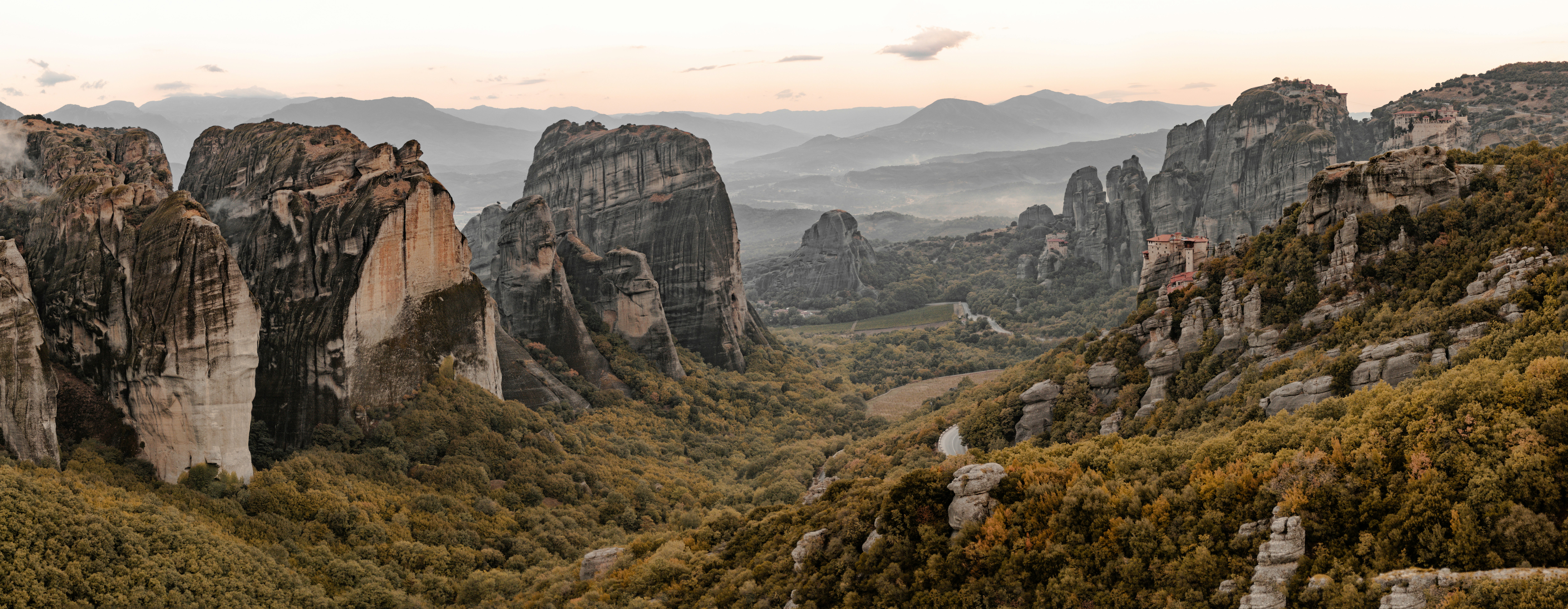 A view of a mountain range with rocks in the foreground