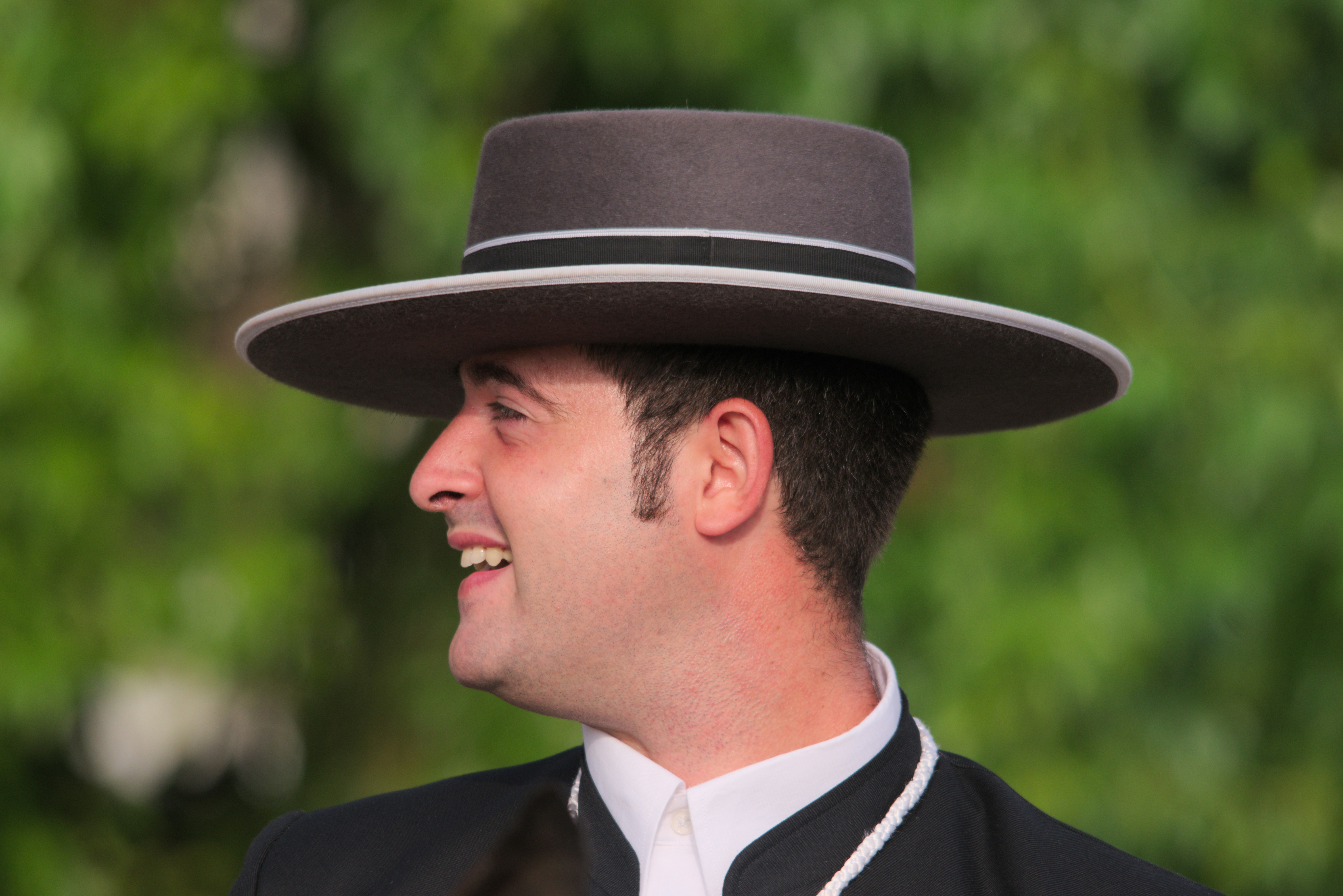 A man in a suit and tie wearing a hat