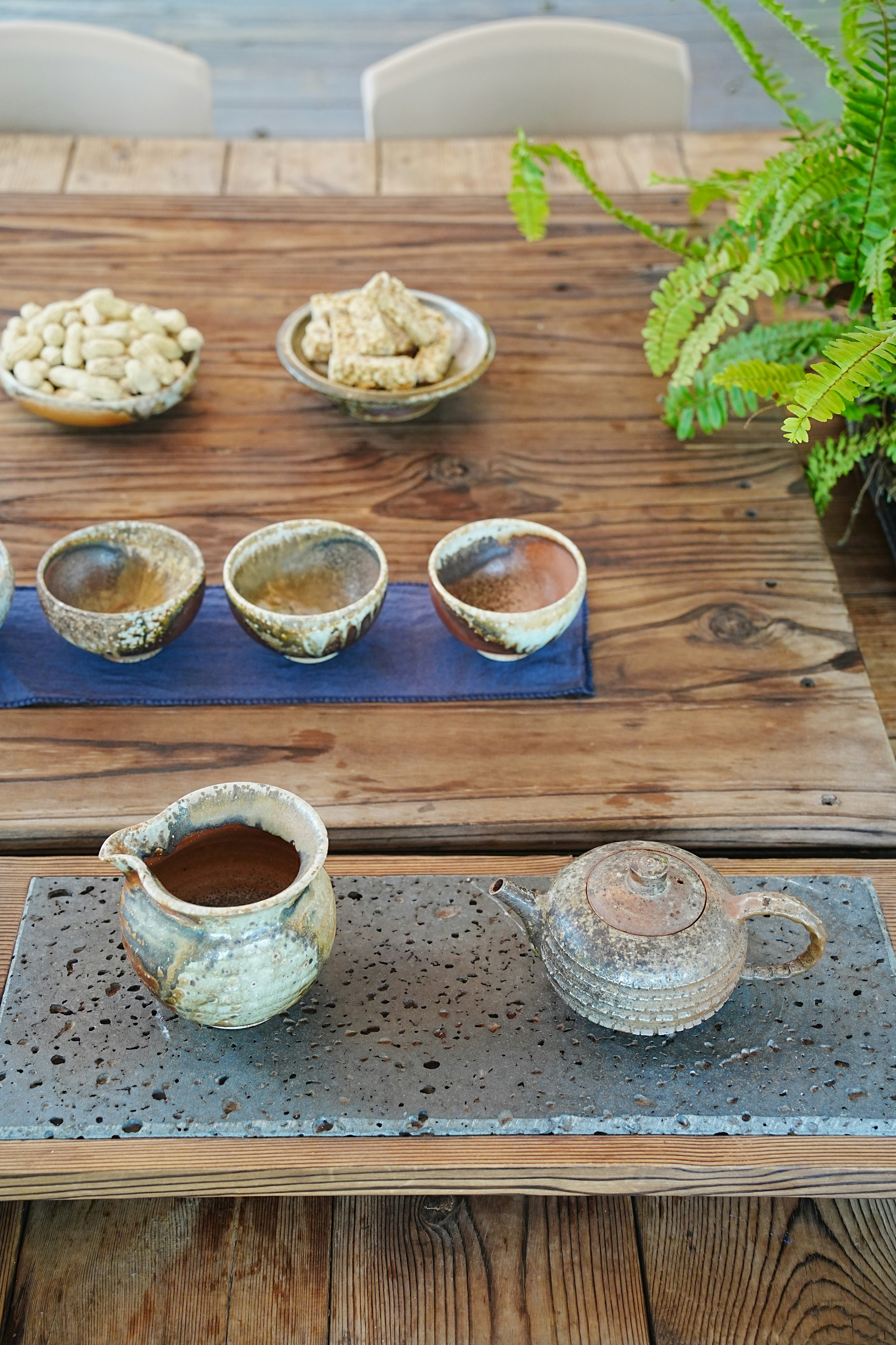 A wooden table topped with bowls of food