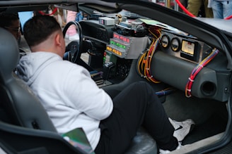 A man sitting in the driver's seat of a car