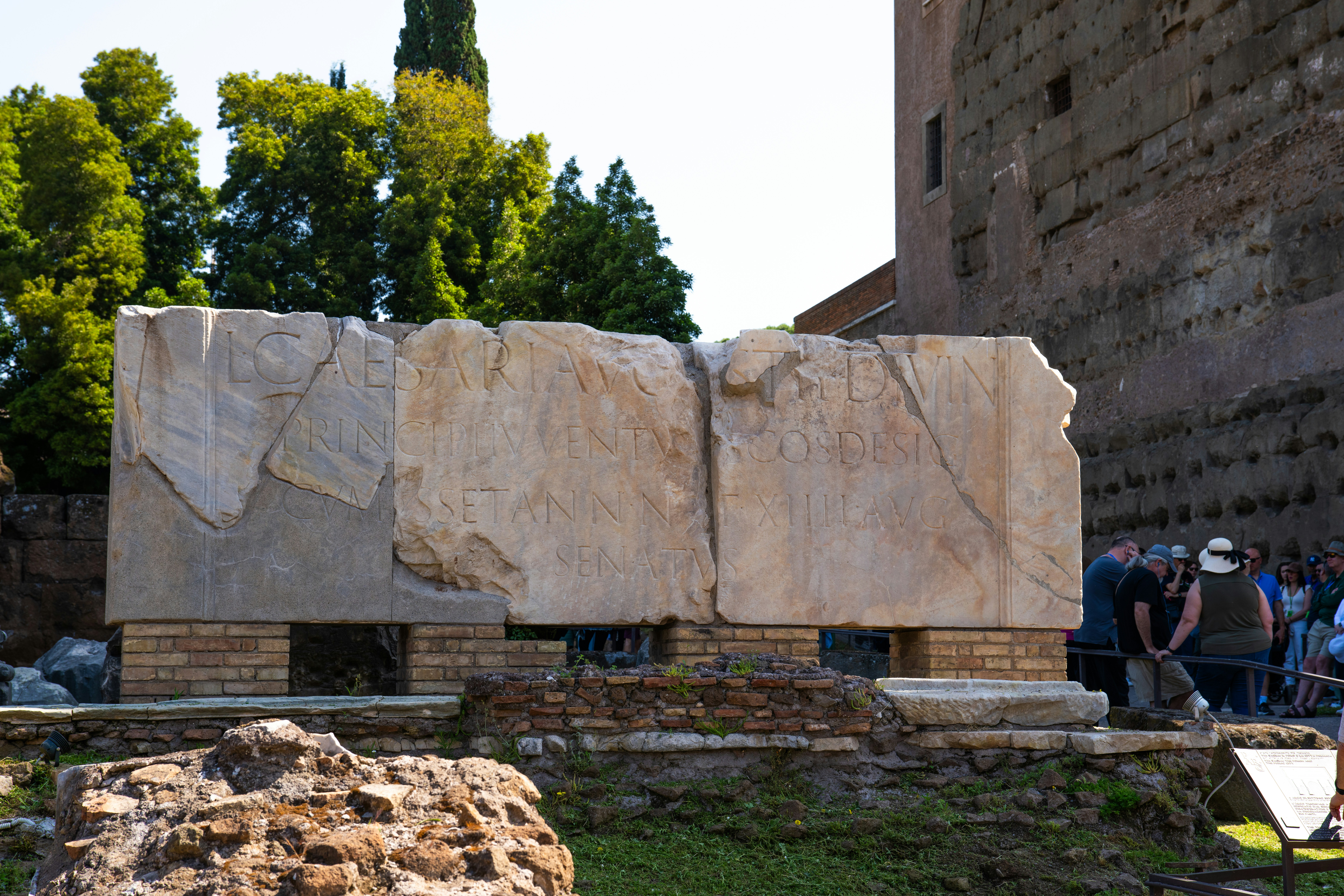 A group of people standing around a stone structure